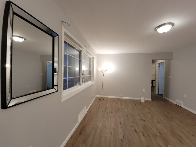 empty room with light hardwood / wood-style floors