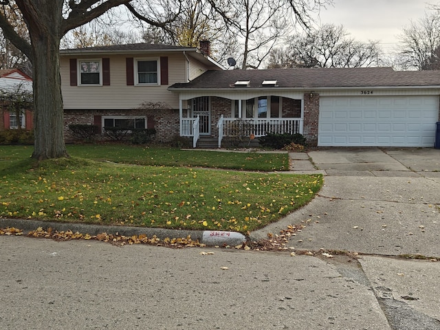 3624 Evergreen Pkwy, Flint, MI 48503 - tri-level home featuring a front yard, a porch, and a garage