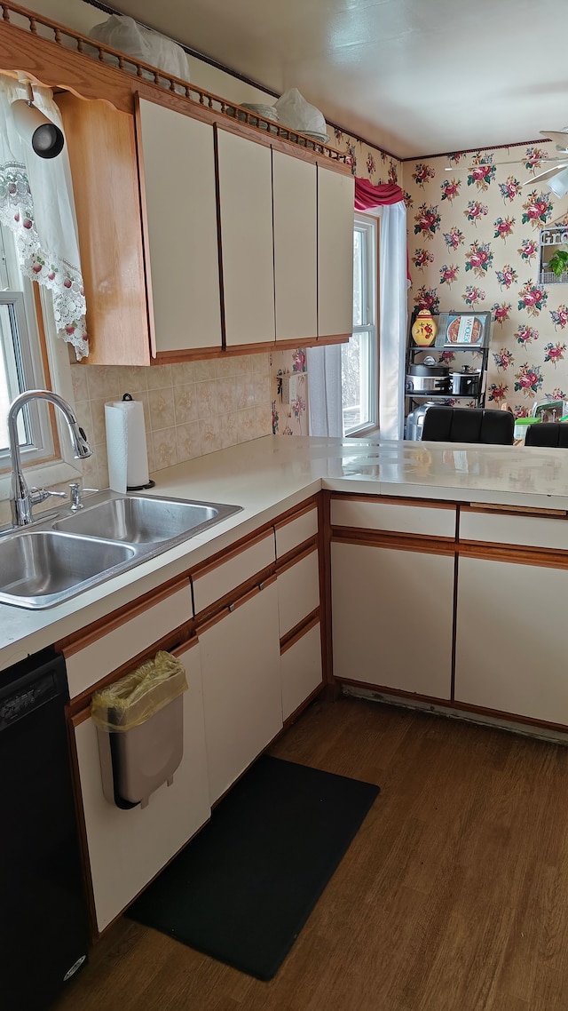 3624 Evergreen Pkwy, Flint, MI 48503 - kitchen with dishwasher, white cabinets, sink, decorative backsplash, and dark hardwood / wood-style flooring