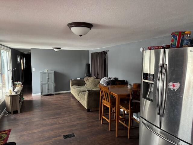 interior space with dark hardwood / wood-style floors and a textured ceiling