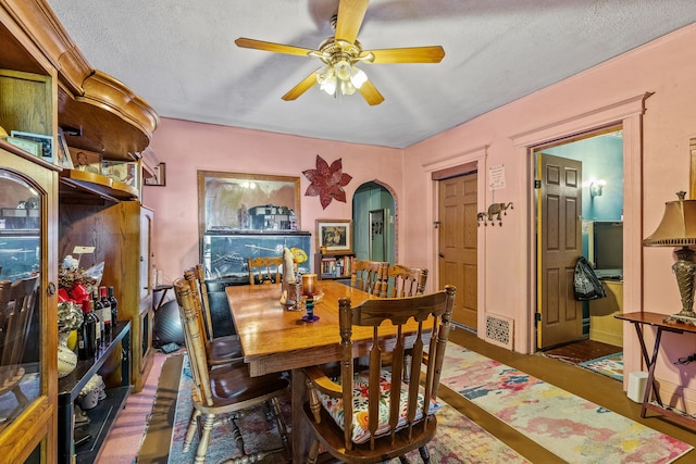 dining room with ceiling fan and a textured ceiling