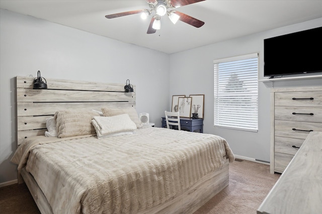 bedroom with ceiling fan and light carpet