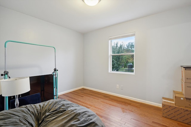 bedroom with hardwood / wood-style flooring