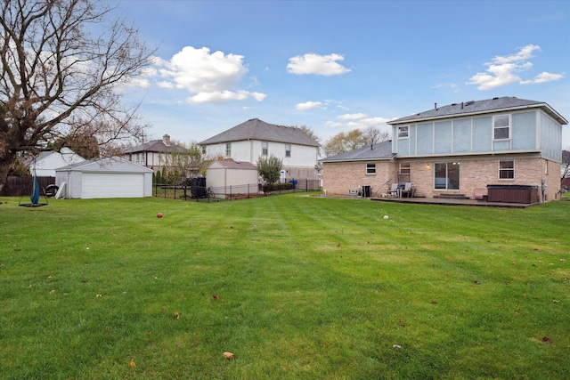 view of yard featuring a garage and an outdoor structure