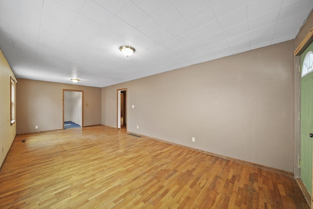 spare room featuring light hardwood / wood-style floors