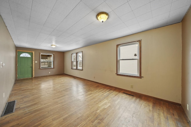 spare room featuring light hardwood / wood-style flooring