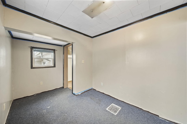 carpeted spare room with crown molding