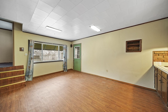 interior space featuring light wood-type flooring and ornamental molding