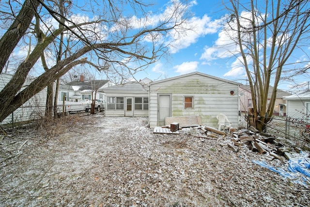 snow covered property with a sunroom