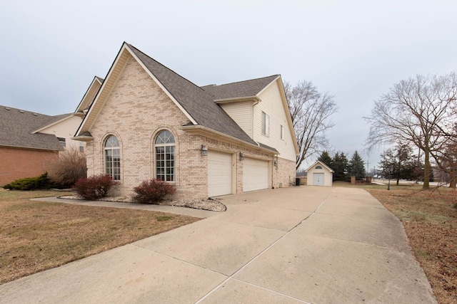 view of side of home featuring a garage and a lawn