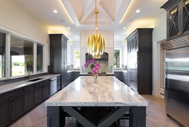 kitchen with sink, stainless steel appliances, light parquet floors, a breakfast bar, and ornamental molding