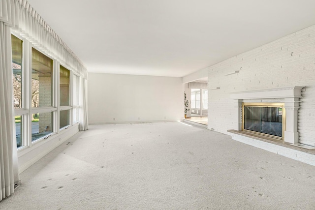 unfurnished living room featuring a fireplace and light colored carpet