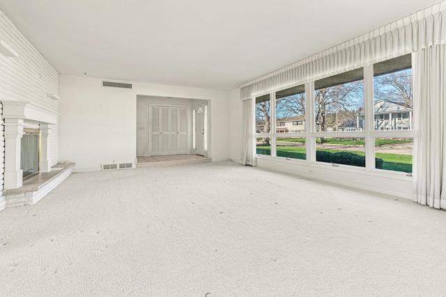 unfurnished living room featuring carpet flooring