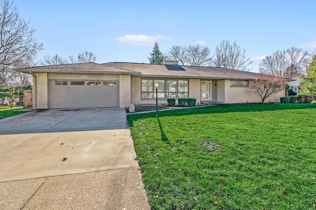 ranch-style home with a garage and a front lawn