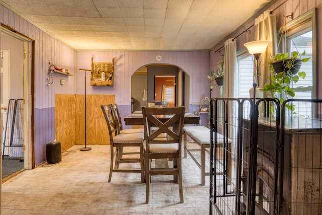 dining room with wooden walls