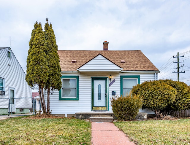 bungalow-style house with a front yard