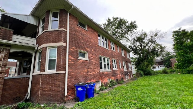 view of property exterior with a yard