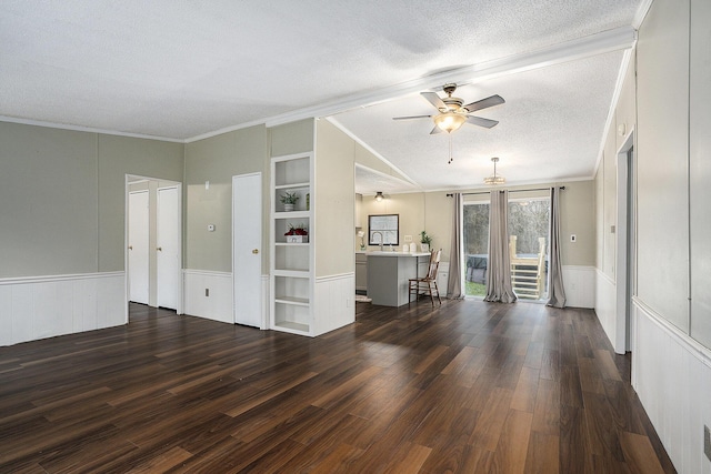 unfurnished living room featuring sink, built in shelves, ceiling fan, ornamental molding, and dark hardwood / wood-style flooring