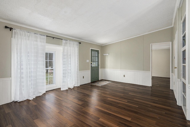 unfurnished room with ornamental molding, a textured ceiling, and dark wood-type flooring