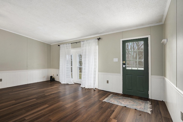 entrance foyer featuring plenty of natural light, ornamental molding, and dark wood-type flooring