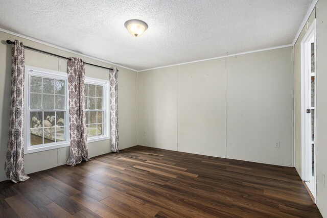 empty room with a textured ceiling and dark wood-type flooring