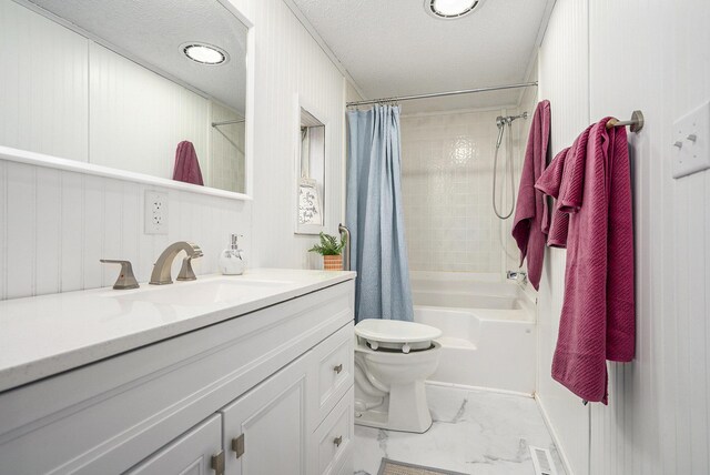 full bathroom featuring shower / bath combo, toilet, a textured ceiling, and vanity