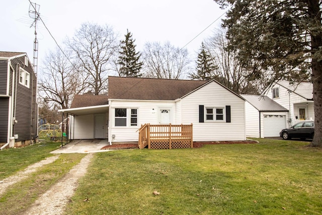 rear view of property with a shingled roof, an attached carport, driveway, and a lawn