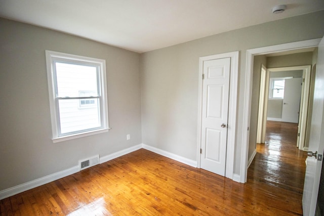 empty room with wood-type flooring