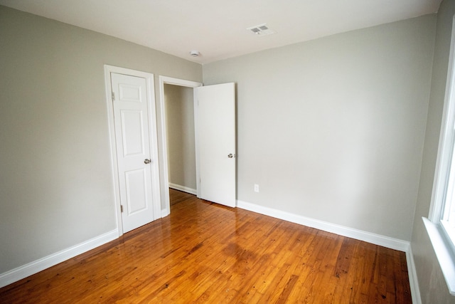 unfurnished bedroom with hardwood / wood-style floors