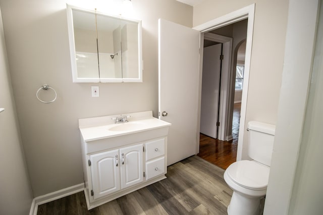 bathroom featuring hardwood / wood-style flooring, vanity, and toilet