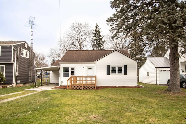 rear view of house featuring a carport and a yard