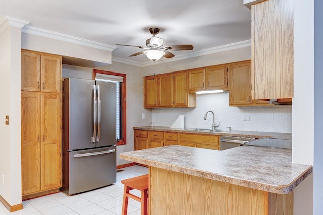 kitchen featuring a kitchen breakfast bar, sink, ornamental molding, appliances with stainless steel finishes, and kitchen peninsula