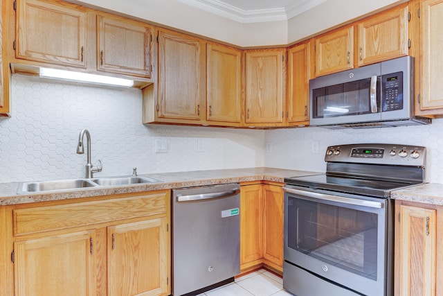 kitchen featuring sink, decorative backsplash, ornamental molding, light tile patterned flooring, and stainless steel appliances