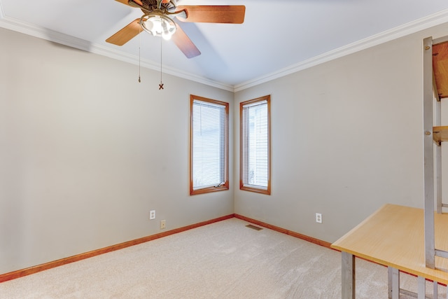 spare room featuring ceiling fan, carpet, and ornamental molding