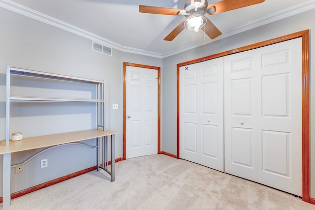 unfurnished bedroom featuring ceiling fan, light colored carpet, and ornamental molding