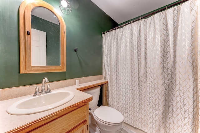 bathroom with vanity, toilet, and walk in shower