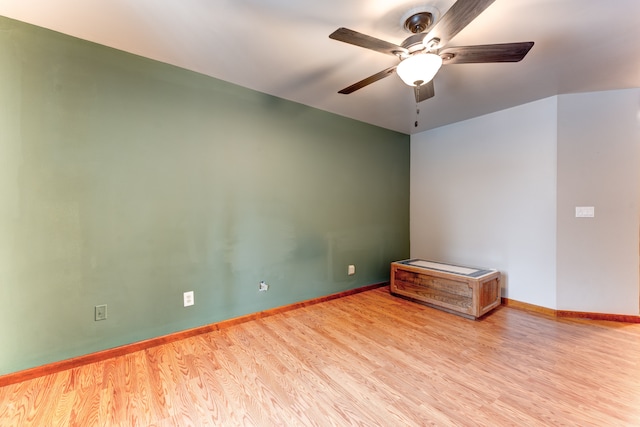 empty room with light wood-type flooring and ceiling fan