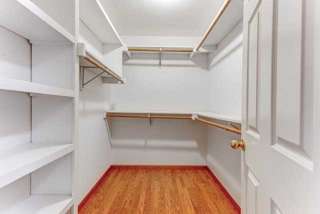 spacious closet with light hardwood / wood-style floors