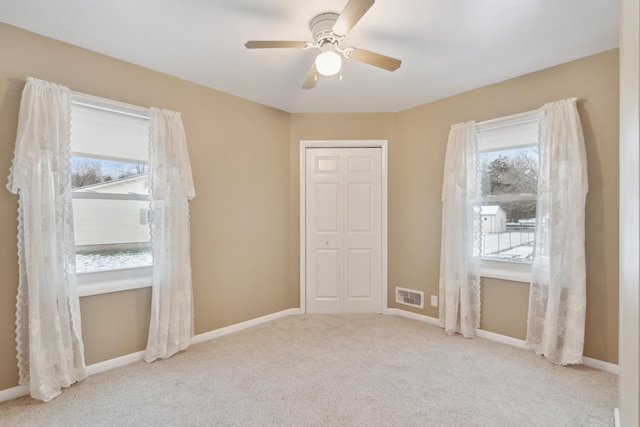 empty room with light carpet and ceiling fan