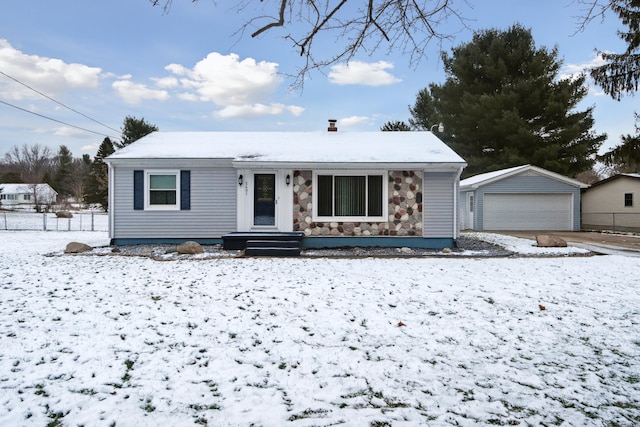 view of front of home with a garage and an outbuilding