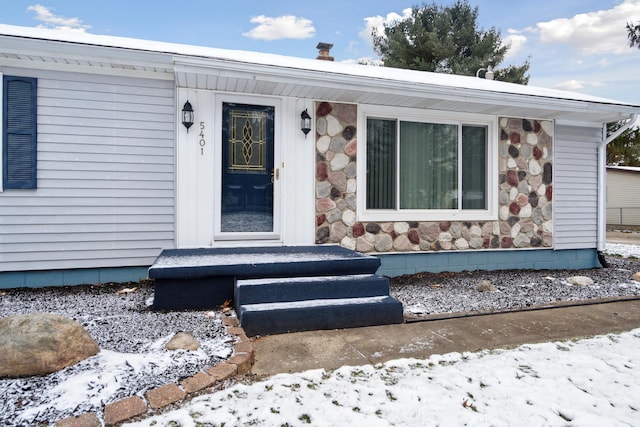 view of snow covered property entrance