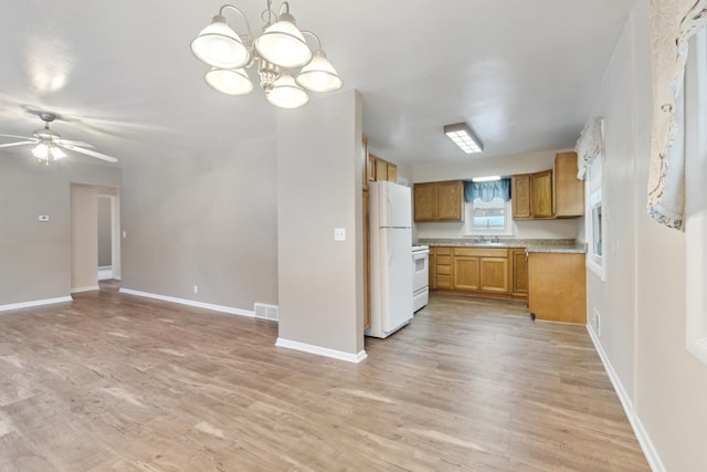 kitchen with ceiling fan with notable chandelier, light hardwood / wood-style floors, white appliances, and decorative light fixtures