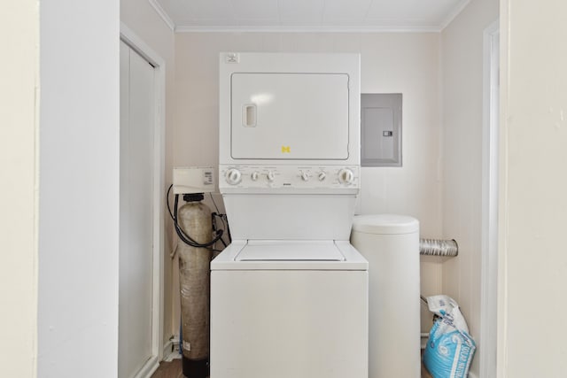 washroom with electric panel, stacked washer and clothes dryer, and ornamental molding