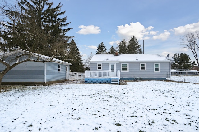 snow covered property featuring a wooden deck