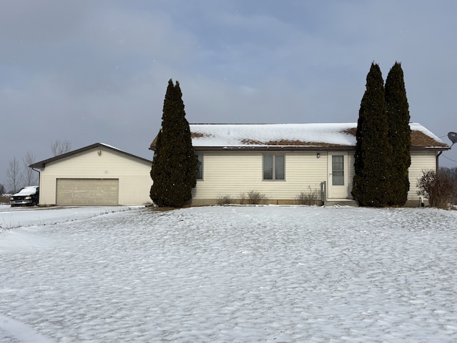 view of snow covered exterior with a garage