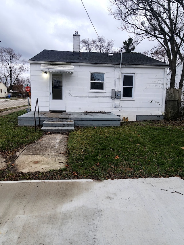 bungalow-style house with a front yard