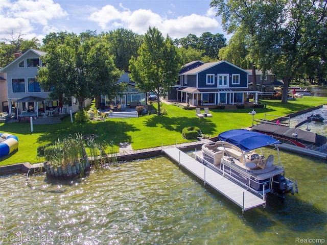 dock area featuring a lawn and a water view