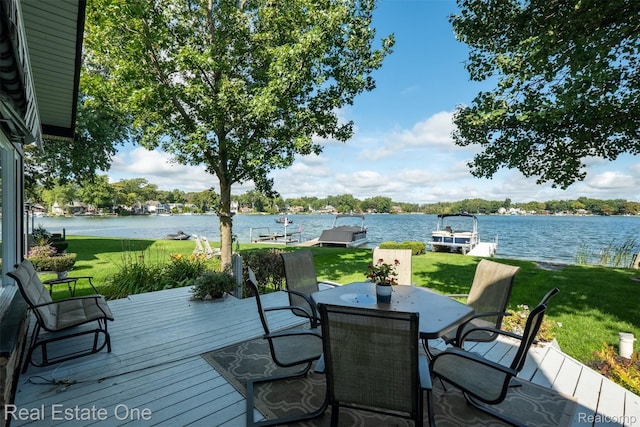 deck with a lawn and a water view