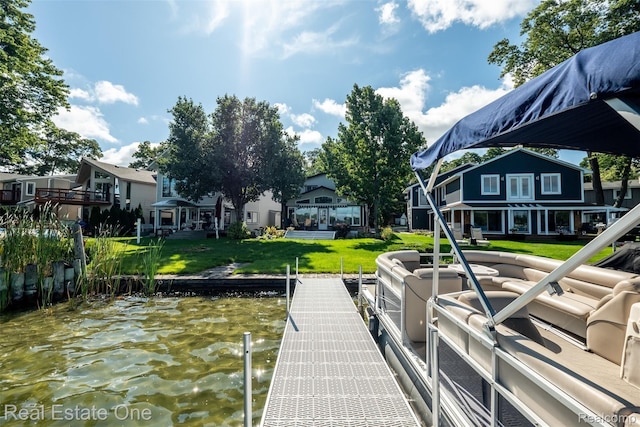 view of dock featuring a water view and a lawn