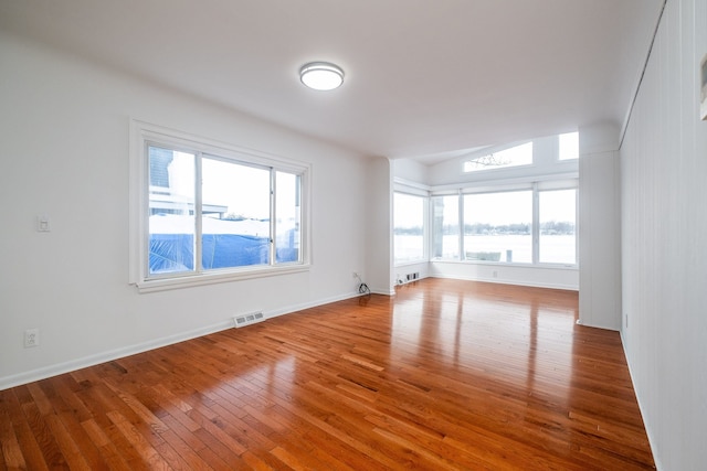 unfurnished room with hardwood / wood-style flooring